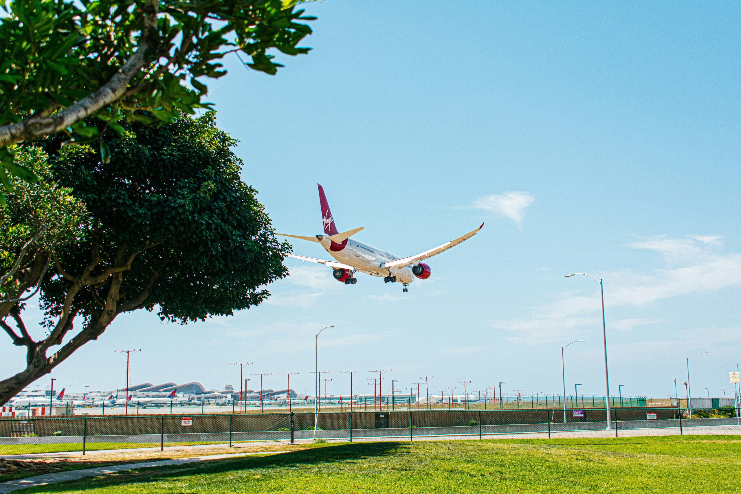 an airplane is flying low over the grass